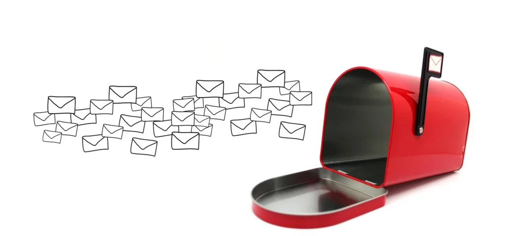 An open, bright red mailbox with its flag raised, sits on a white background as a swarm of hand-drawn letter envelopes floats towards it. E-mail marketing and automation