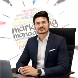 Rohit Upadhya, founder of Digitophile digital marketing agency in Siliguri, sitting at a desk in a blue suit jacket with a marketing strategy typography graphic background